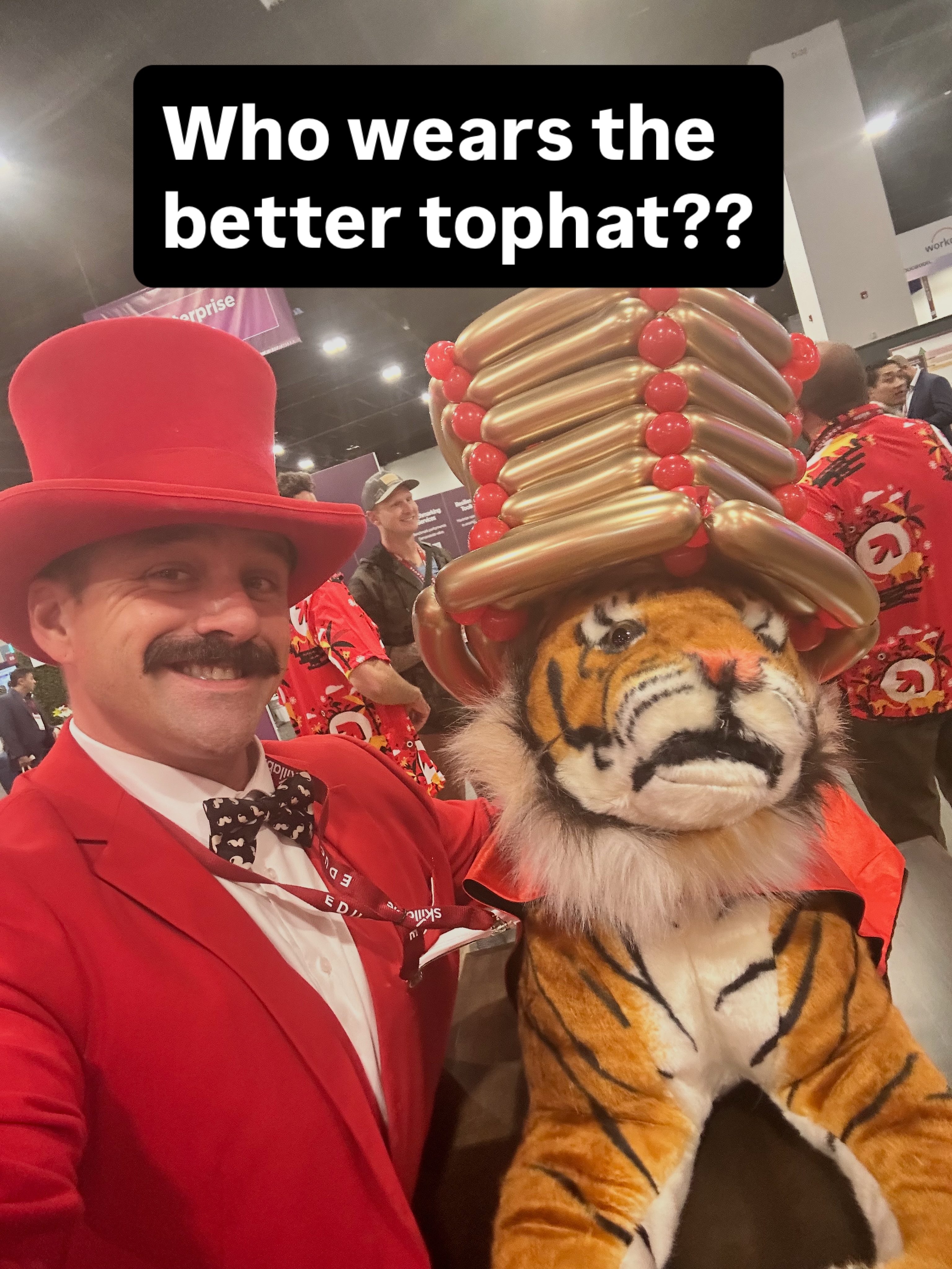 Which one of us wears the top hat better?