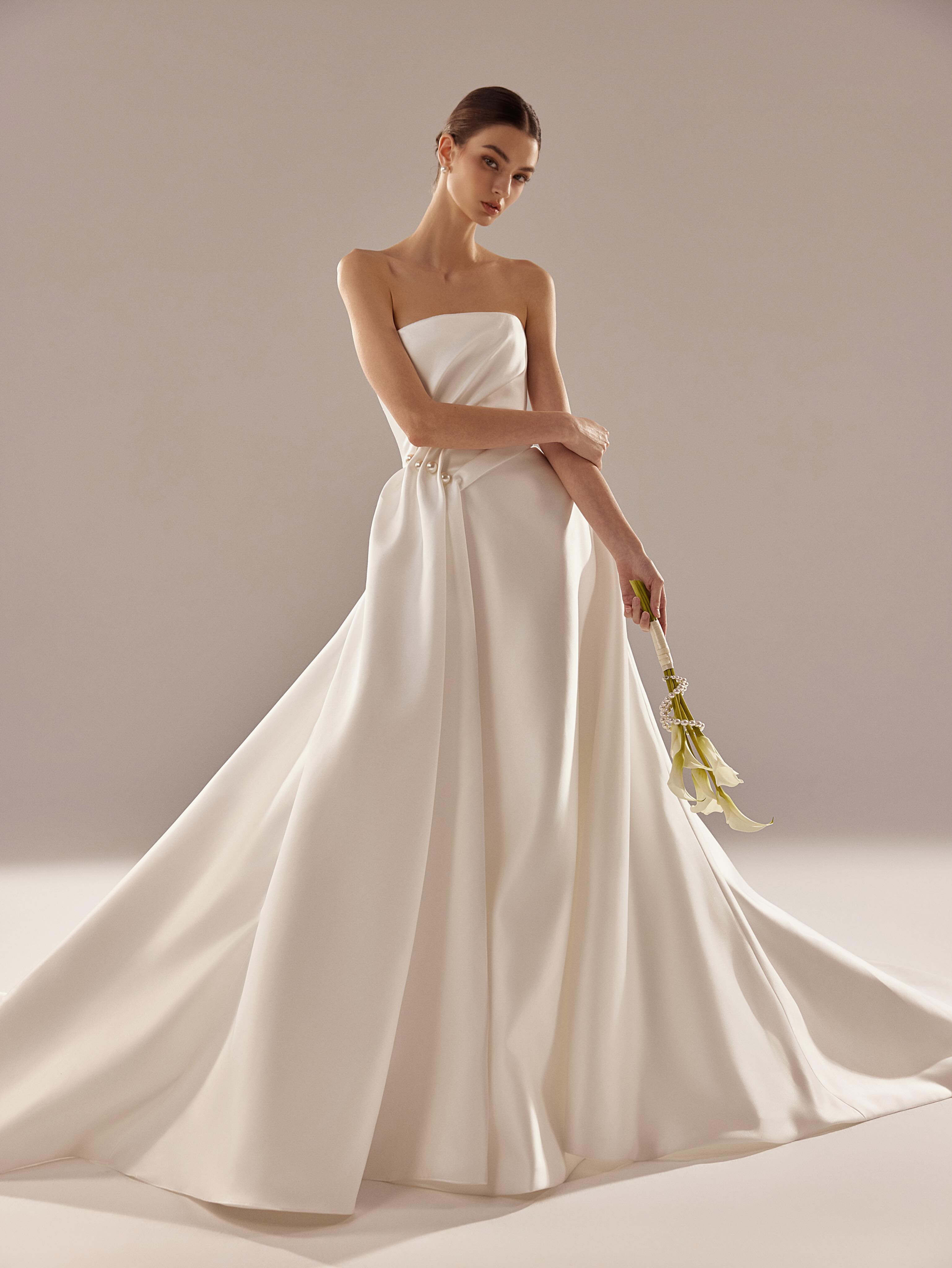 Classic, with an unexpected twist.
A modern strapless A-line wedding gown defined by an asymmetric draped bodice and sculptural skirt. Delicate pearl accents gather at the waist, creating a subtle statement against the clean, timeless silhouette.
Minimal from afar. All in the details up close.
Available at Cherie Amor Bridal in Orange County, California.
#alineweddingdress #minimalistweddingdress #californiabride #2027bride #cherieamorbridal