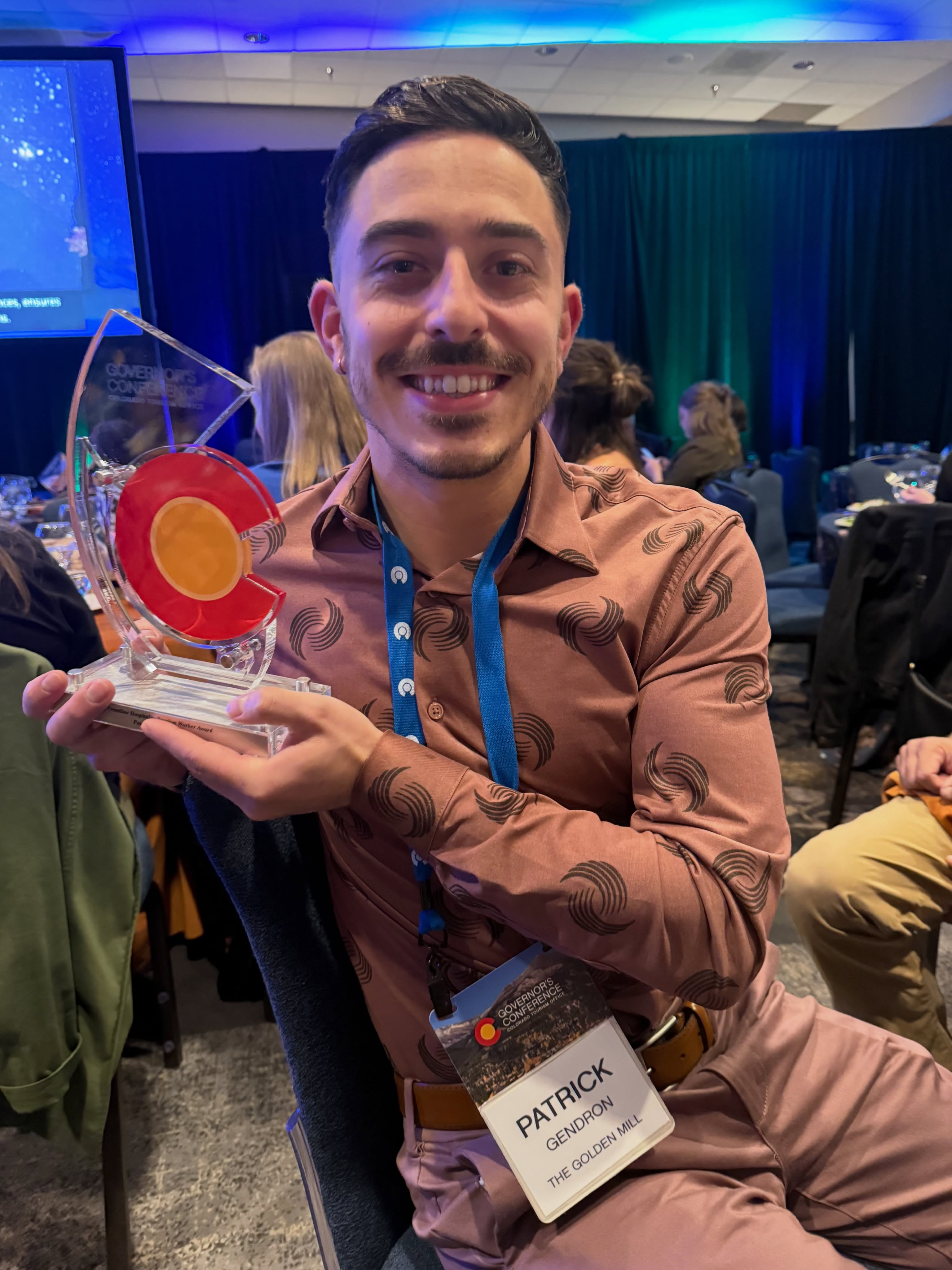 This one’s a big deal, and we couldn’t be more excited to share it: Patrick Gendron, a Golden Mill Ambassador, was honored at this year’s Governor’s Awards Ceremony and named the 2026 recipient of the Colorado Tourism Office’s Frontline Hospitality Tourism Worker Award, recognizing his outstanding contributions to hospitality and tourism.
If you know Patrick, this comes as no surprise. He shows up for our guests and his coworkers in ways big and small, every single day. From launching our Event Ambassador program to leading the charge on Golden Mill Pride Fest, and supporting this community at every turn. He is the heart of this place, and this award belongs to all of us who get to call him part of the crew.
Please join us in celebrating Patrick — we’re endlessly proud of you, and this recognition is so, so well-earned 🎉