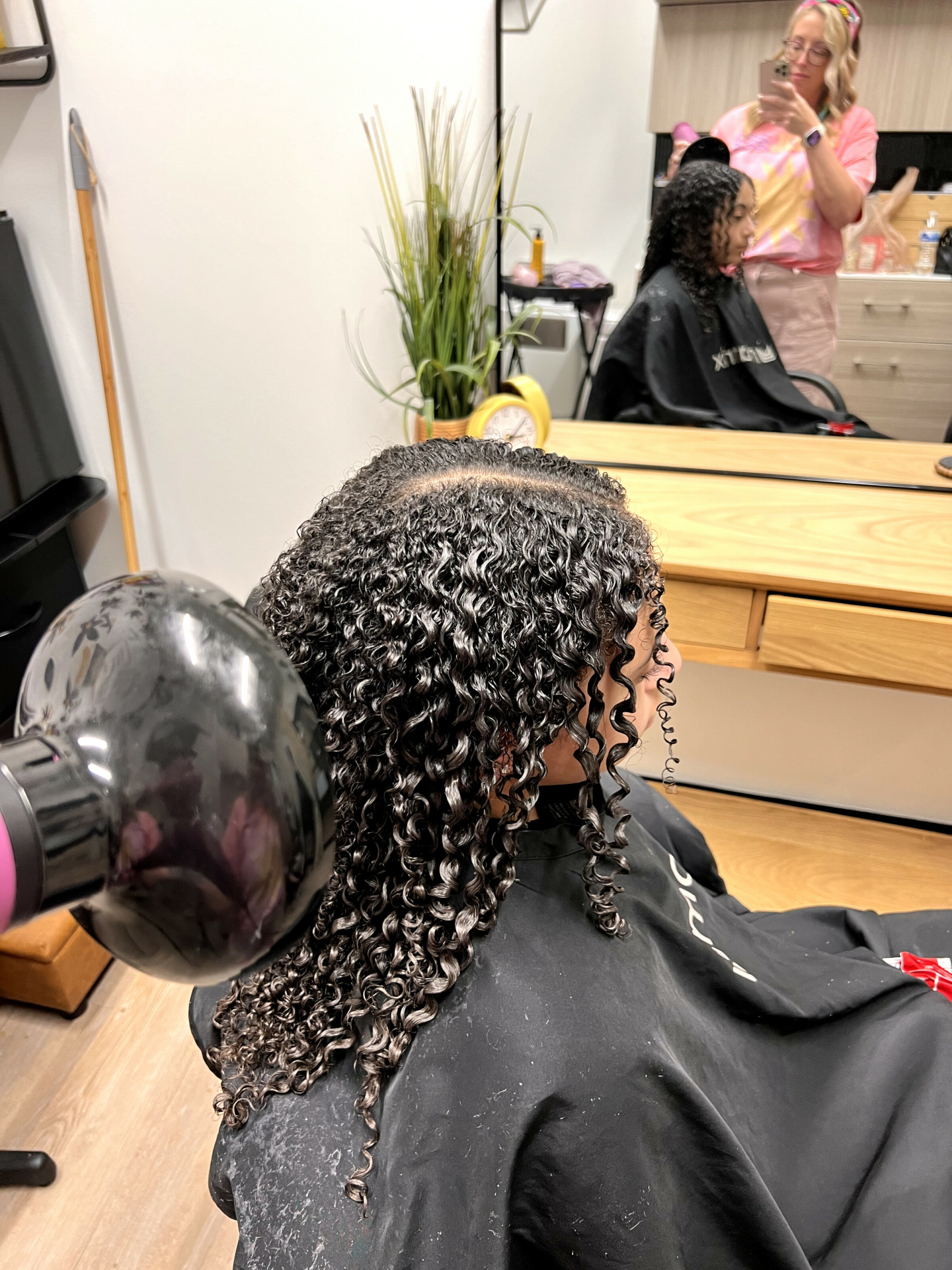 Raise a 🤚🏼🤚🏾🤚🏿 if you've ever felt victimized by the amount of time it takes to diffuse your curls.
We totally understand! It is not usually a quick or simple styling solution, but it does help set the cast in your curls so you can go on with your day and not worry about them falling or getting frizzy because you didn't spend time getting them to their full potential.
A few things to consider before diffusing that can add or take away time:
1. Can you get away with taking a little bit of water back out of the hair before applying your product? If your curls aren't seriously dehydrated, sometimes drying with your towel for just a few extra seconds can speed the process up a lot.
2. Gel stays wetter longer. Mousse dries faster. If you're in a hurry, mousse might be a better answer.
3. For wavy & curly hair, use butterfly clips to scrunch and clip up your hair. Diffuse for a few minutes, then continue getting ready. Wear the clips all the way to work if you want! Clipping your hair up can let more air through it so it ultimately dries faster, as well as helps boost your pattern since gravity won't be pulling down on your wet curls.
What are your fave hacks for diffusing?