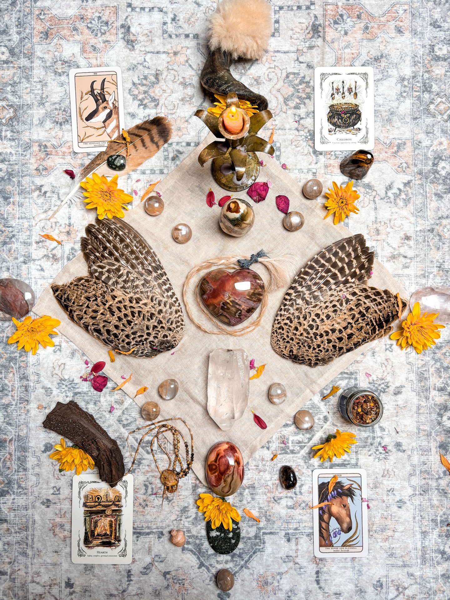 October Altar 🍁
For me this altar came at a potent turn within my life, I created it today as when I create my altars I need to dedicate time & energy for their creation. They are rituals that allow me to set new intentions for the month but also give me time to sit & meditate, contemplate, reflect & pour my energy into the present moment.
This particular season in TCM is connected to grief & as I allow myself to inquire within this emotion & shift there have been 3 things I have had to energetically & physically let go of this month already.
The crystals I have used are petrified wood (the chunky heart!), lemurian quartz, polychrome jasper, tigers eye, peach moonstone, fire quartz, preseli bluestone, Smokey quartz. These have all intuitive came together to bring me this deep foundation of grounding, a sturdy energy that holds me as I navigate a new way of seeing things as I shed & let go of layers. I’m specifically working with my new fire quartz pieces from my gorgeous babe @fernandclayco & they are giving me the deepest sleep!
The cards really have given me guidance this month & made me smile as I sat with them:
The Antelope & Wheat: Nourishment. Focuses on community support, collective prosperity & filling your cup through connection.
Cauldron: Creation, Opportunity, Caring. Highlights self-transformation, brewing fresh ideas, creative problem-solving & nourishing oneself & others.
Hearth: Safety, Comfort, Spiritual Connection. Represents the spiritual heart of the home, inner warmth, light, rejuvenation & honouring sacred relationships.
The Horse & Bluebell: Modest Fortitude. Symbolizes quiet strength, humble endurance, steady process over external validation & staying dedicated to the journey.
There are a few other token pieces on the altar, the Ganesh blend helps connect me to invoke Ganesh, allowing me to release obstacles within my path, the bird wings remind me of the seasonal changes, the wind & air within my heart to remind me of my freedom, the plaited hair is from my mamas horse who we sadly said goodbye to earlier in the week, this altar is dedicated to her. 🌹
V x
#altar #medicinewheel #crystalmandala #crystalgrid
