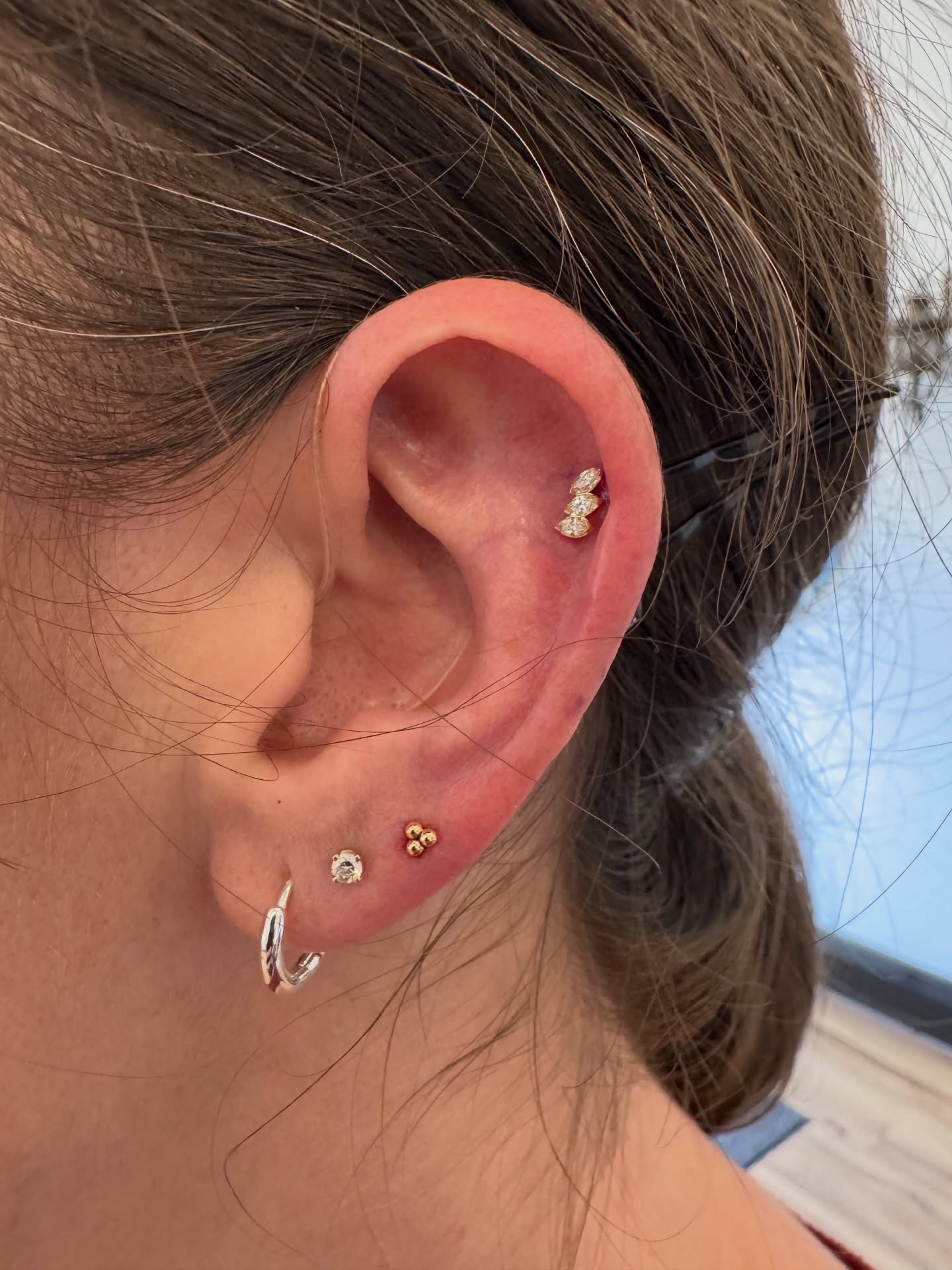 Lovely addition to this clients ears, with her third lobes and a conch. 2nd lobes previously done with @bvla prong set cubic zirconia, 3rd lobes also BVLA tri-bead cluster, both 14k solid gold. Conch is done with @anatometalinc marquise fanfare end, 18k gold with cubic zirconia.
Piercings done by Jason, aka @estesparkpiercer
Piercing studio is open Friday-Monday, 11am to 6pm. Come get adorned!