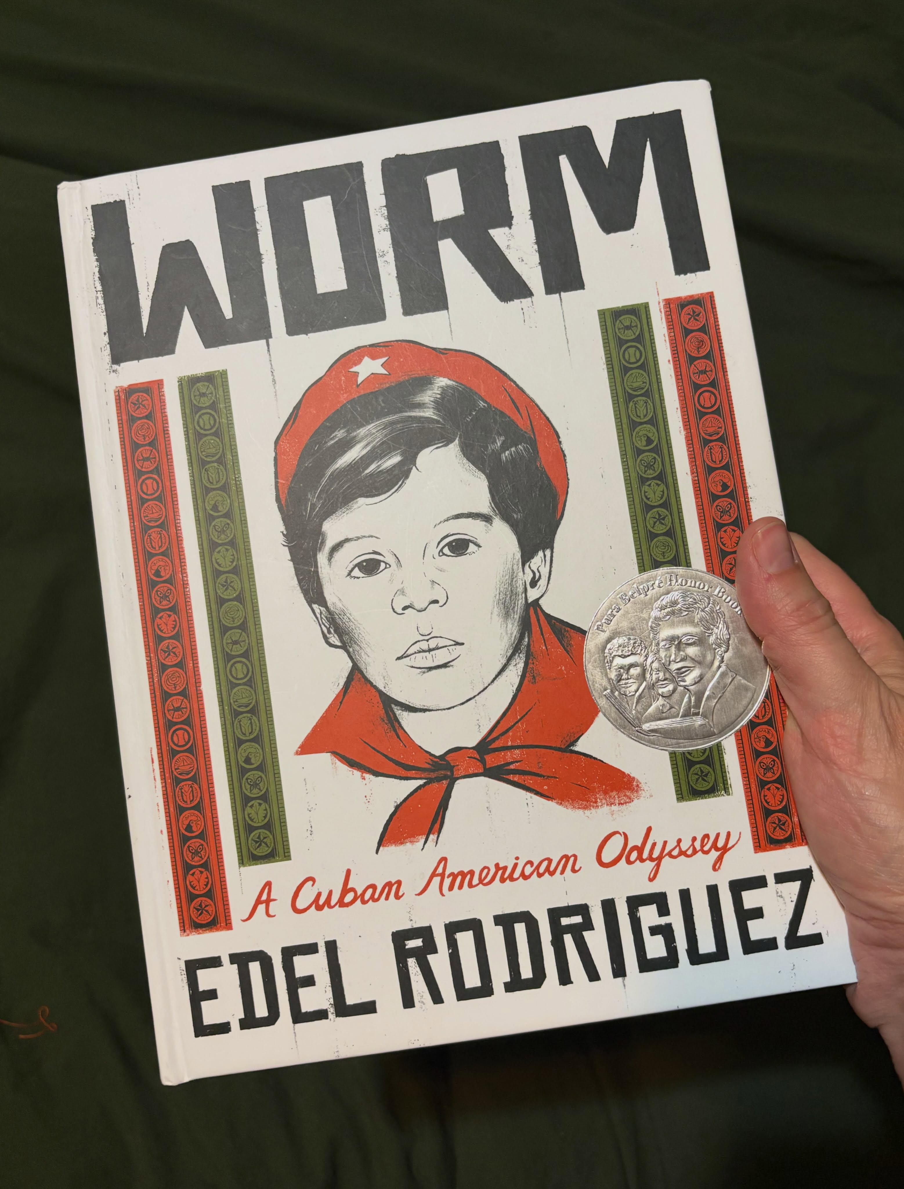 I love a good graphic novel. There’s nothing quite like a well told story paired with beautiful illustrations, so I was very excited to get my hands on a copy of @edelrodriguezstudio ’s Worm when it came out a couple years ago. I’ve been a fan of Edel’s work since I first discovered it as an art student in the early 2000’s. It’s graphic and bold, very conceptual, often political, and always beautifully drawn.
Worm is the story of Edel’s childhood in communist Cuba and how his family was eventually able to escape and move to the United States. He begins by explaining how Cuba became communist, and then each subsequent chapter is a different story and a snapshot of Cuban life at that time, showing how things slowly changed for the worst. I love a story that shows me a perspective that is different than my own, and prior to reading Worm, I had no idea what life in communist Cuba would have been like, or what a family would have gone through in order to leave. It’s a really great book.