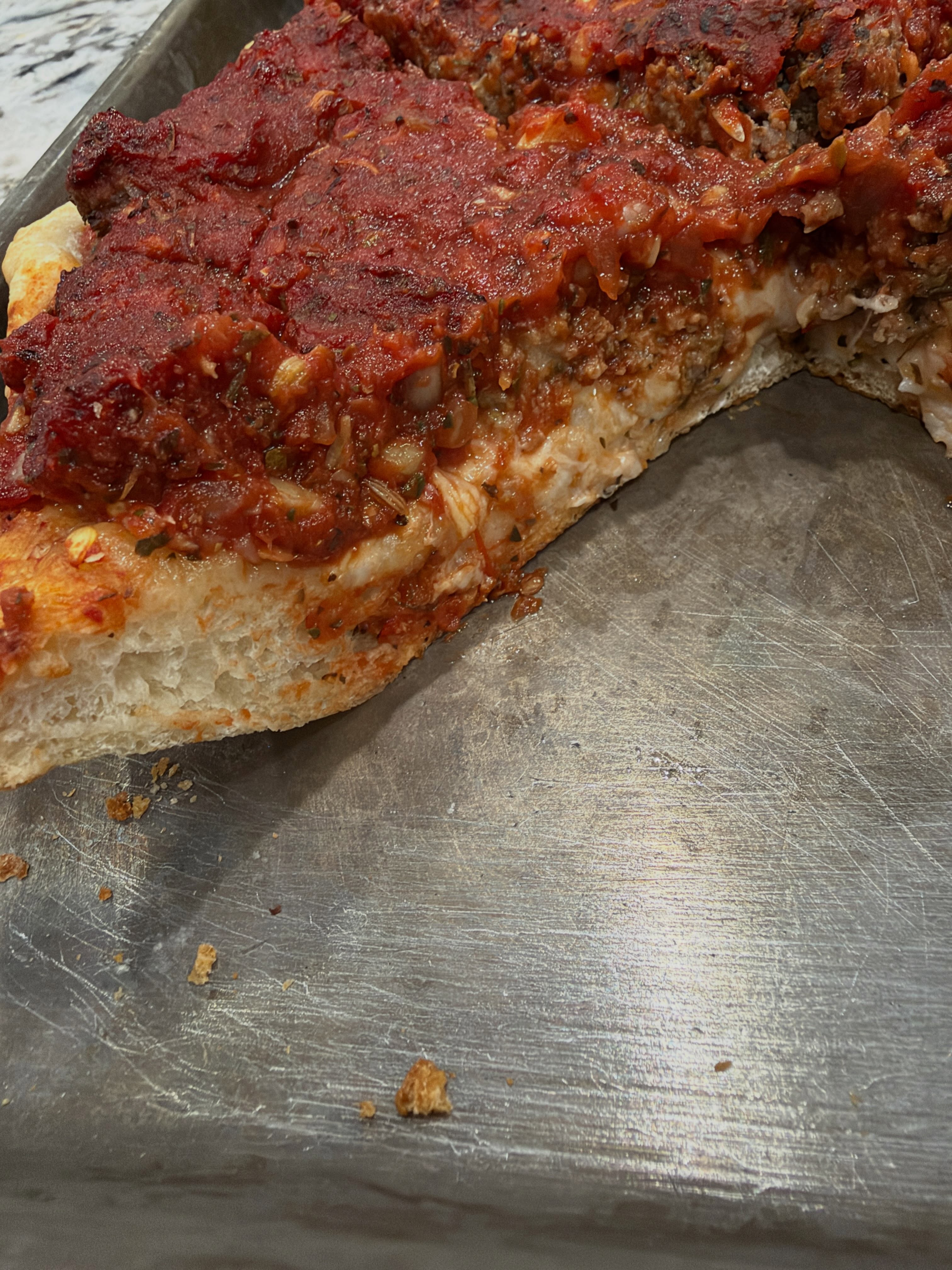 Upside Down Pan Pizza…
Why is the sauce on top? Because this one is built upside down.
This is the first test of a take-and-bake pizza I’ve been kicking around.
It’s inspired by Chicago-style pizza, but made with my pizza dough instead of a traditional buttery Chicago crust.
Mozzarella goes down first, followed by the toppings (in this case, meatball), then my Pizzeria-Style Pizza Sauce goes on top.
The cheese helps protect the dough from the moisture in the thick, hearty sauce while everything bakes.
I’m pretty happy with how it turned out. The crust baked all the way through, held everything up, and still had a nice soft, airy interior.
The plan is to keep it simple with just a few varieties:
Cheese
Meatball
Roasted Mushroom
Sausage & Peppers
There’s a little more R&D to do, but I think Upside Down Pan Pizza has a future here…
Stay tuned to find out when these will be available for sale at @joplinempitematket.
💜 Made by hand. Bottled with attitude. Powered by farms.
Follow Purple Chin Condiment Co. for more Flavor Anarchy.