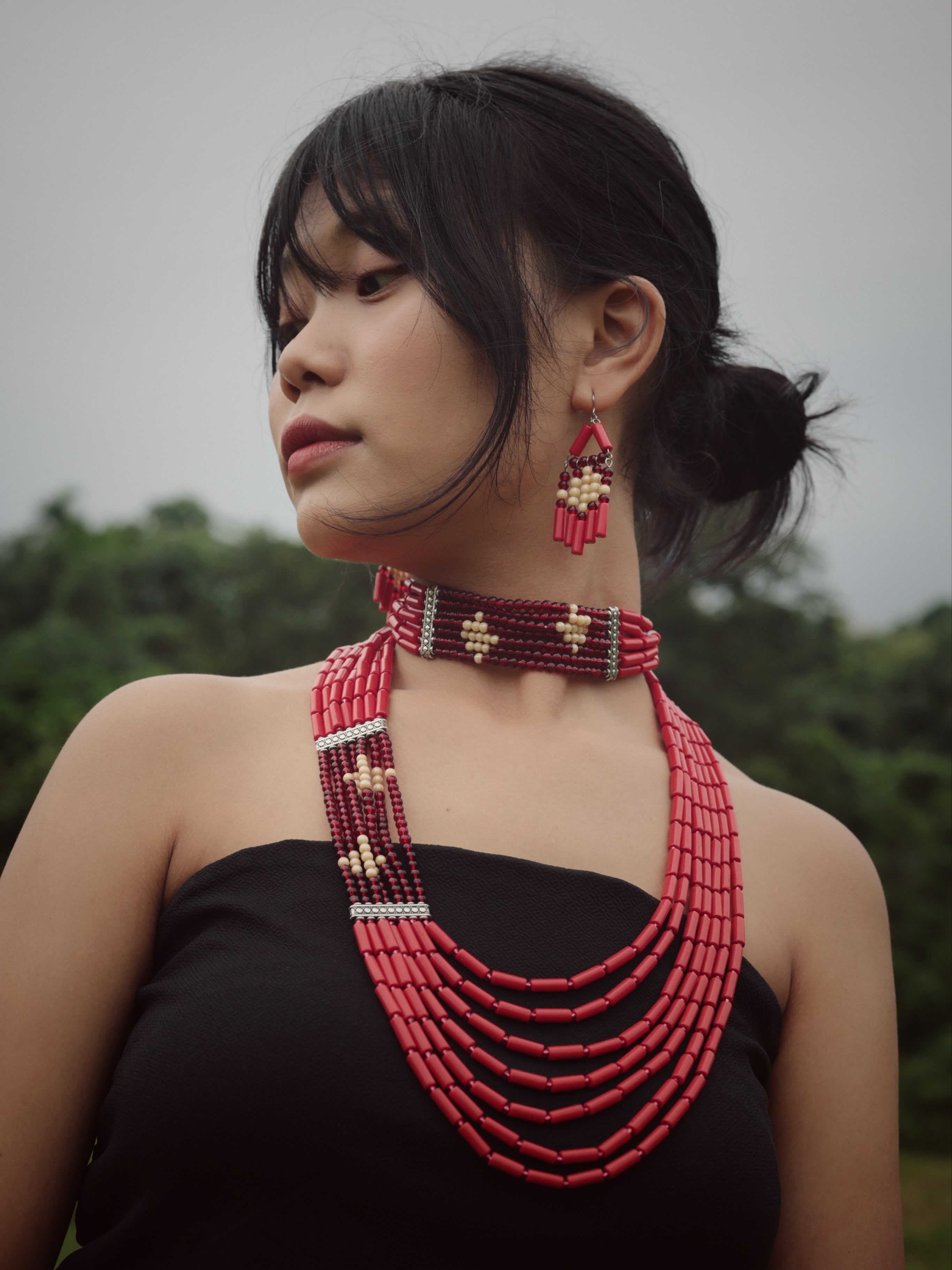 A striking combination of scarlet red, wine burgundy and ivory cream defines this interpretation of the Garo diamond motif.
Featuring the Scarlet Red Diamond Motif Necklace with Earrings, matching Choker and Hairstick.
The Diamond Series
Edition One
Scarlet Red Diamond Motif Necklace with Earrings
Scarlet Red Diamond Motif Choker
Scarlet Red Diamond Motif Hairstick